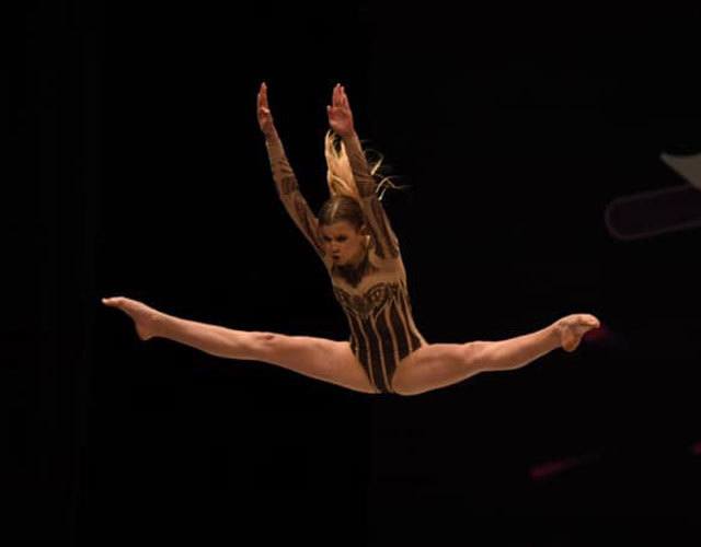 a woman jumping up in the dark