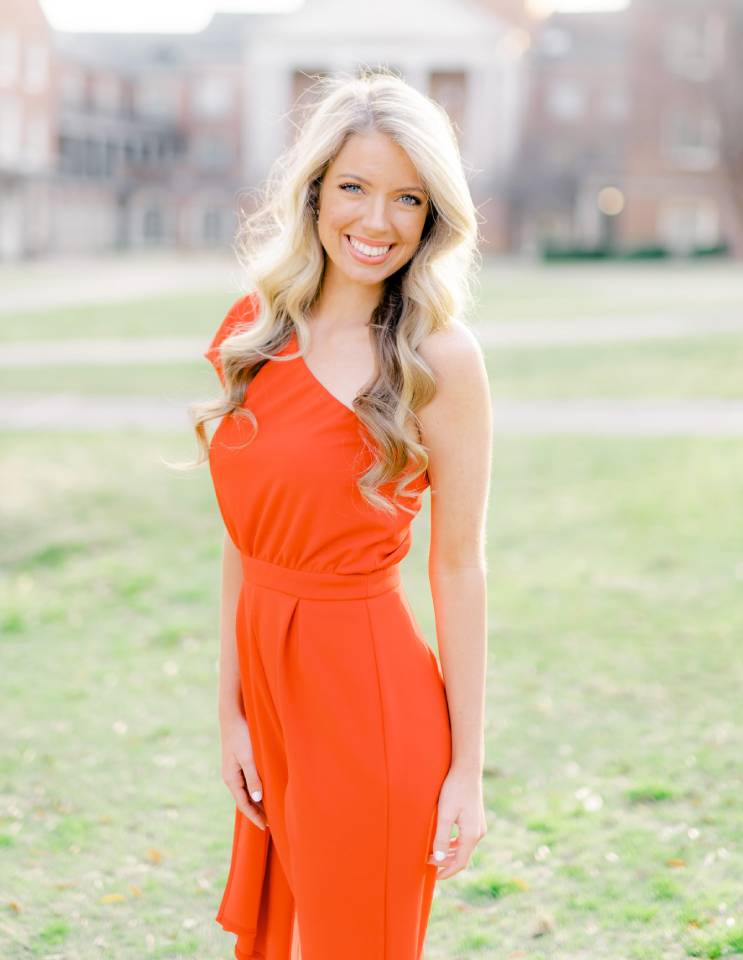 a woman wearing an orange dress