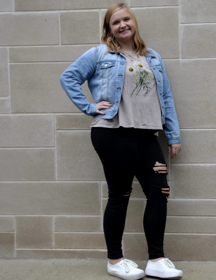 a person standing in front of a brick building